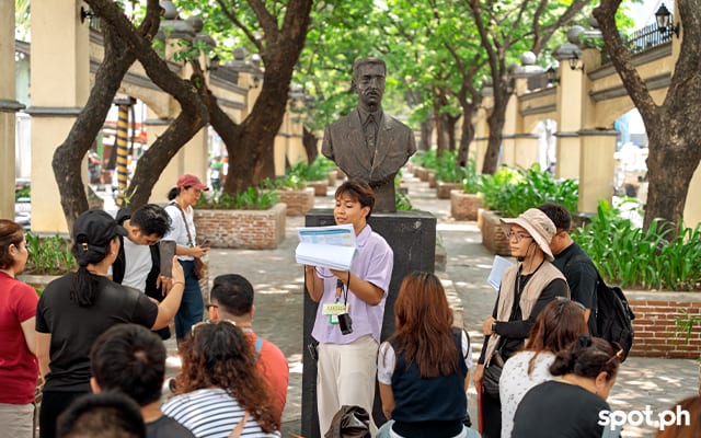 The group stops at Plaza Moriones to read an excerpt from Banaag at Sikat by Lope K. Santos